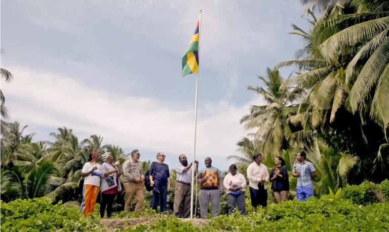 Flag raising in the chagos archipelago at peros bahnos